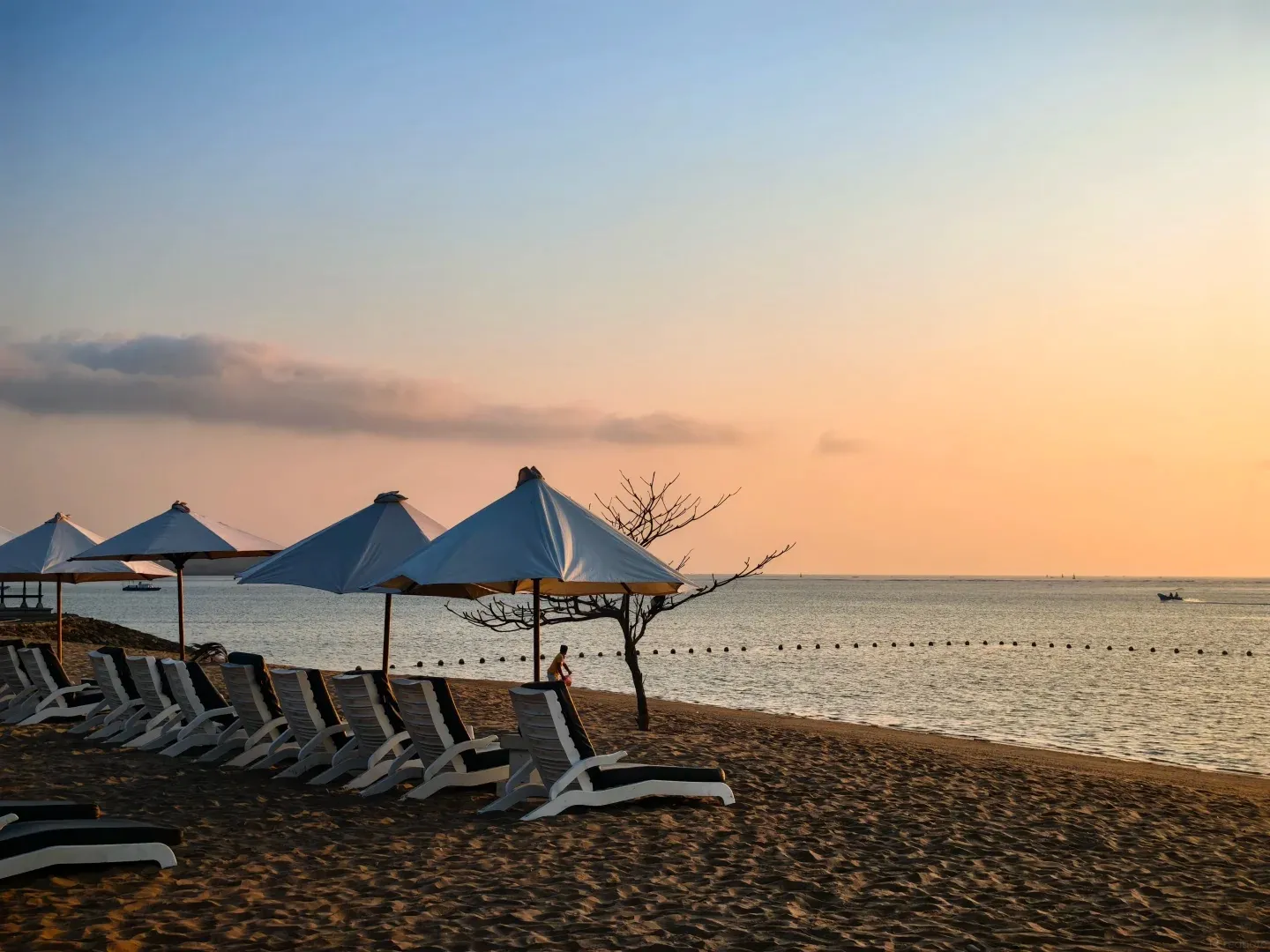 Loungers and umbrellas on the beach at sunset