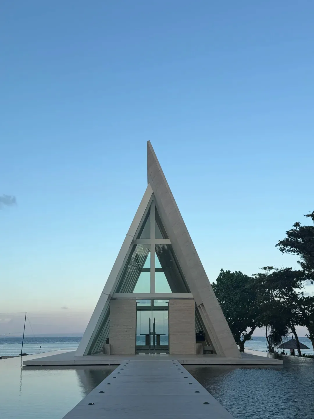 The glass wedding chapel standing over a reflecting pool