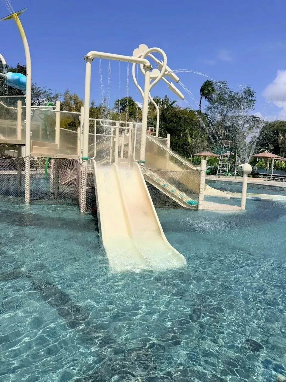 A double slide on a splash play tower in the shallow kids pool