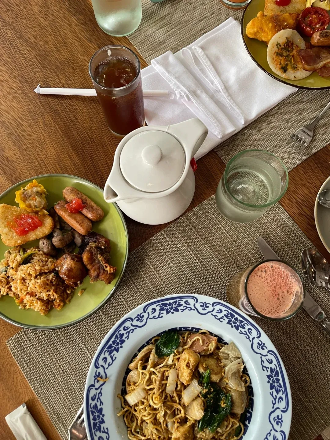 Lunch of noodles, fried rice and Indonesian dishes on a table