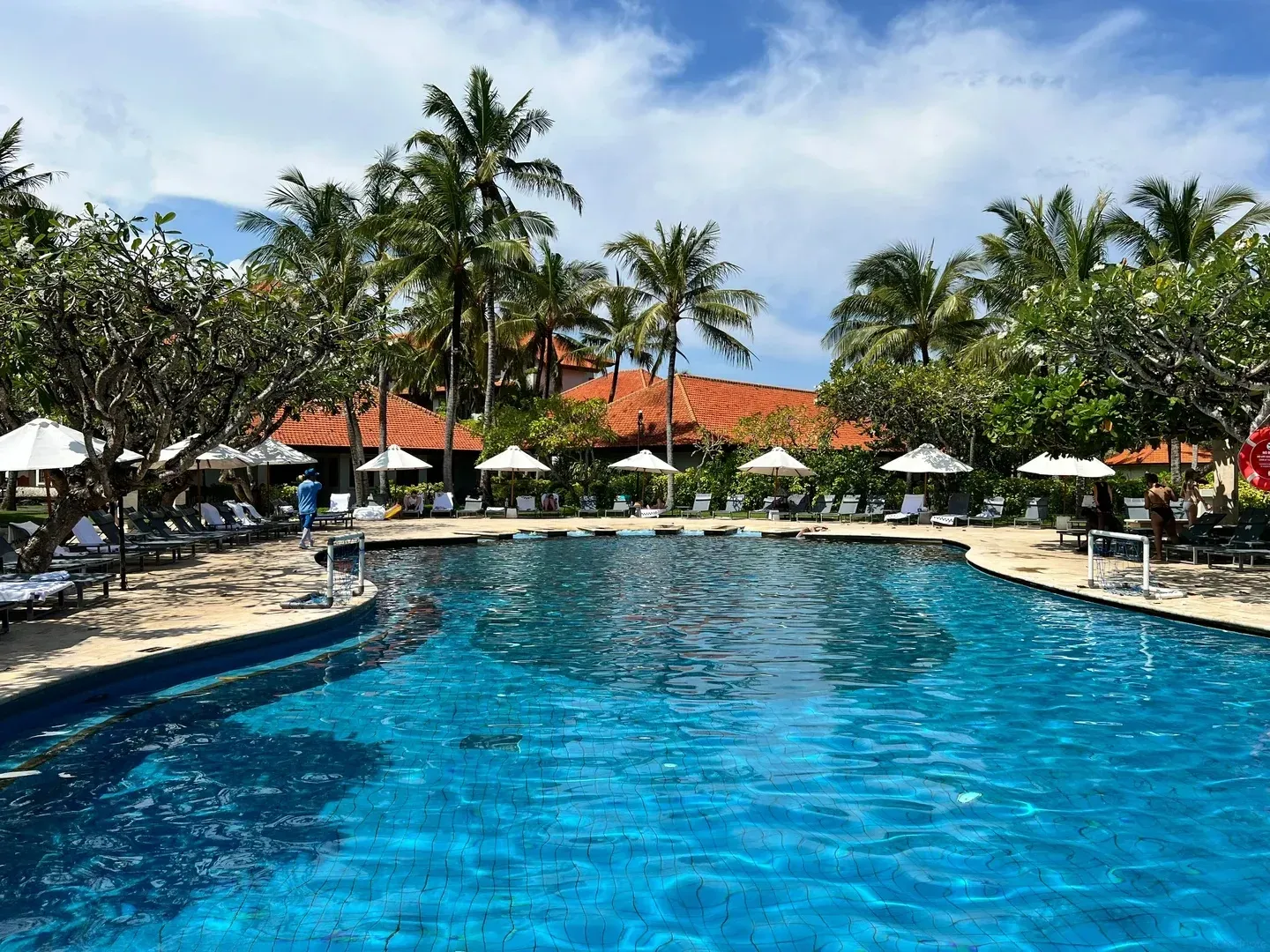 The main pool at Grand Hyatt Bali, with water polo goals and sun loungers under umbrellas