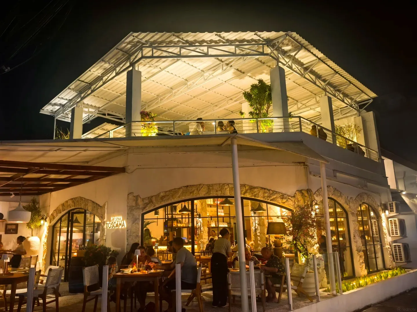A two-storey restaurant pavilion lit up at night